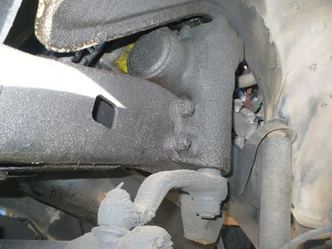 1986 Toyota Land Cruiser - Underside view of heavily greased vehicle suspension components, with no clear year identification.
