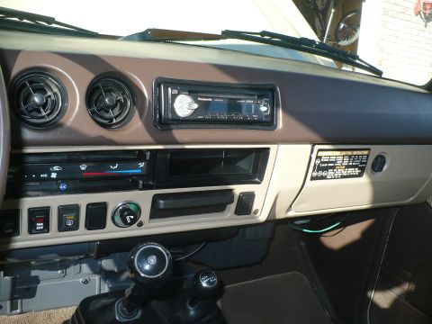 1986 Toyota Land Cruiser - Interior view of a vehicle's dashboard, showing the center console with climate controls and gear selectors.