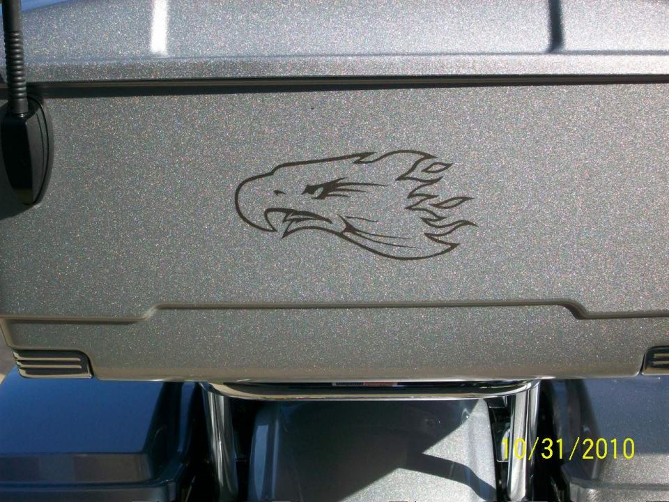 Gray motorcycle saddlebag with an eagle head decal and a date stamp of 10/31/2010