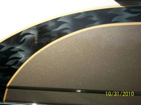 2009 Harley-Davidson FLH - Close-up of a motorcycle fender flame graphics and a textured, glitter-infused paint finish. Watermark indicates photo taken on 10/31/2010.