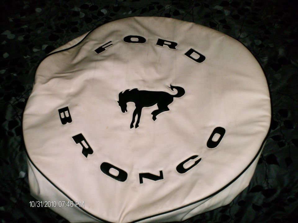 White tire cover with black Ford Bronco lettering and a black horse silhouette
