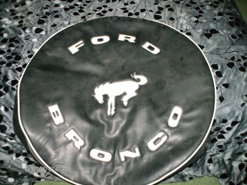 1996 Ford F-150 - Spare tire cover the Ford Bronco logo and running horse emblem.