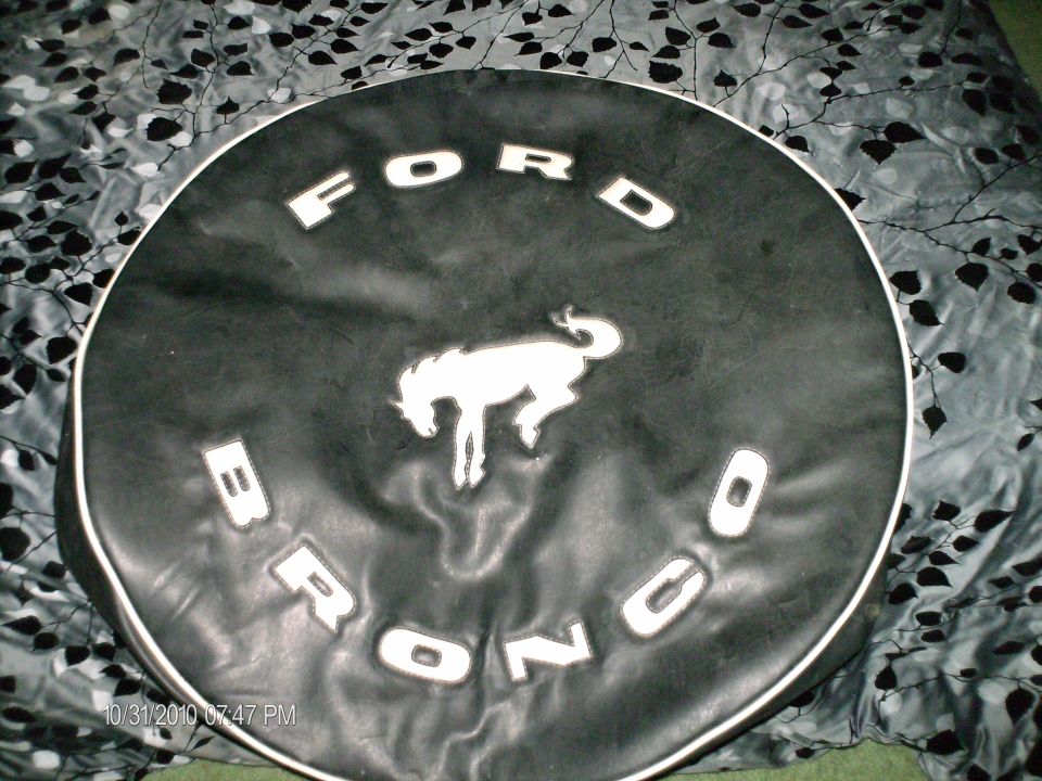 Black Ford Bronco spare tire cover with white running horse logo