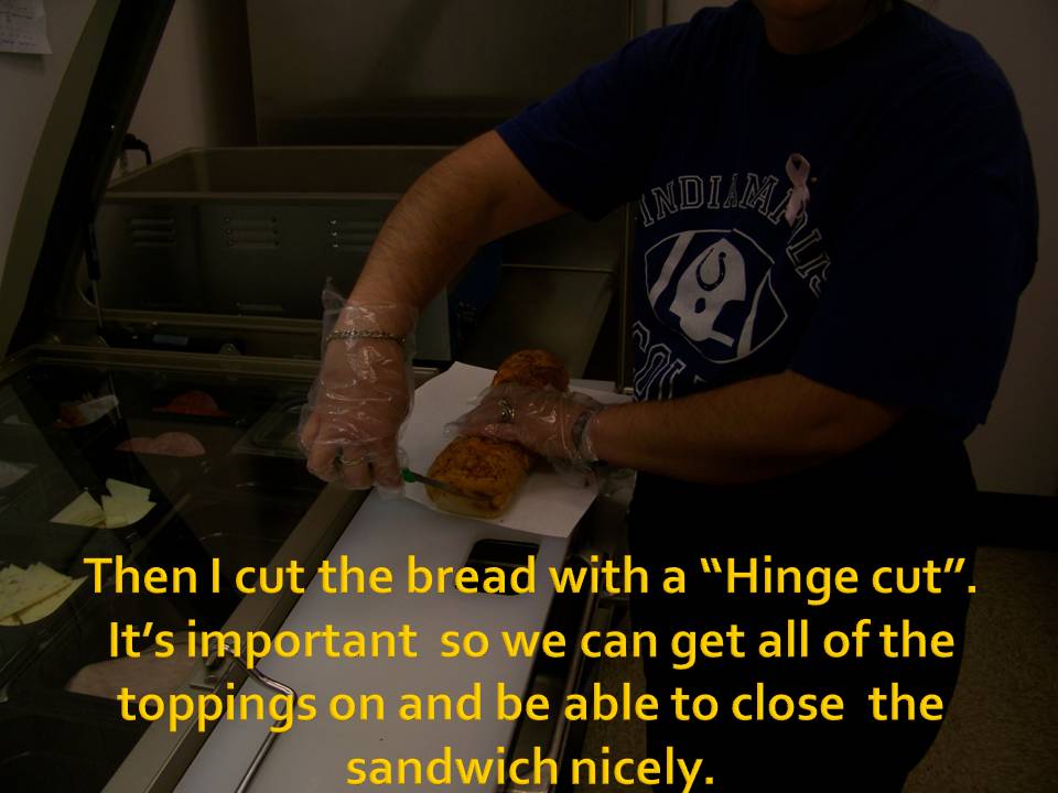 Person wearing gloves cuts a sandwich on a cutting board. Text overlay describes the "Hinge cut"