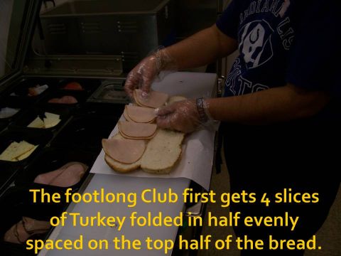 1989 Ford Bronco - A footlong club sandwich is being prepared with four slices of turkey.