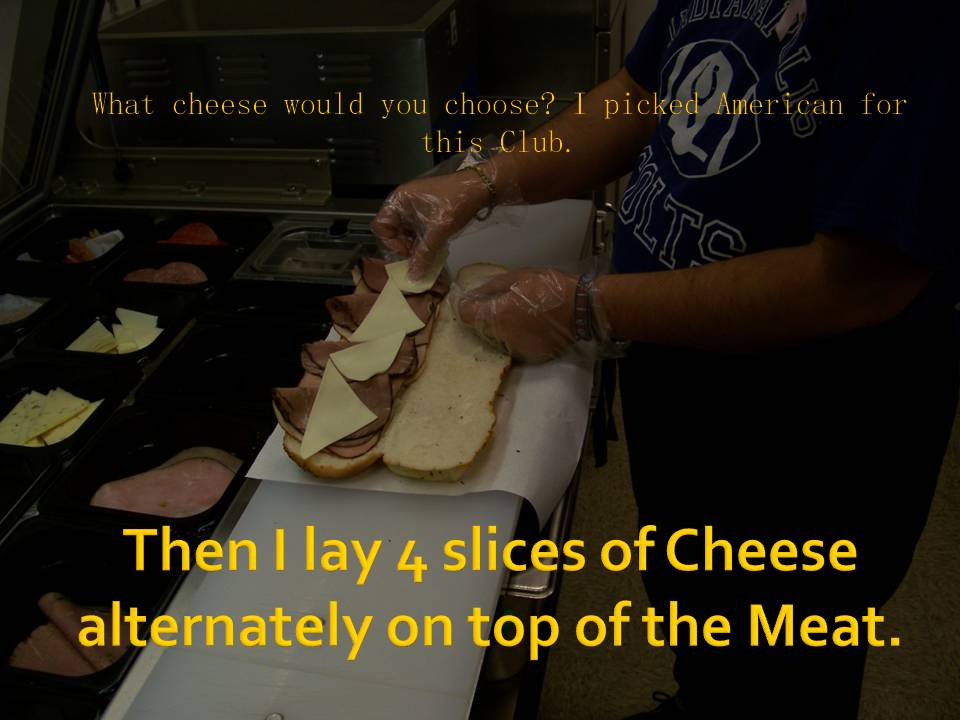 Person making a sandwich, adding cheese slices on top of meat
