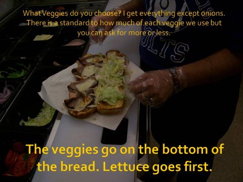 1989 Ford Bronco - A person is making a sandwich, adding lettuce and meat to the bread.