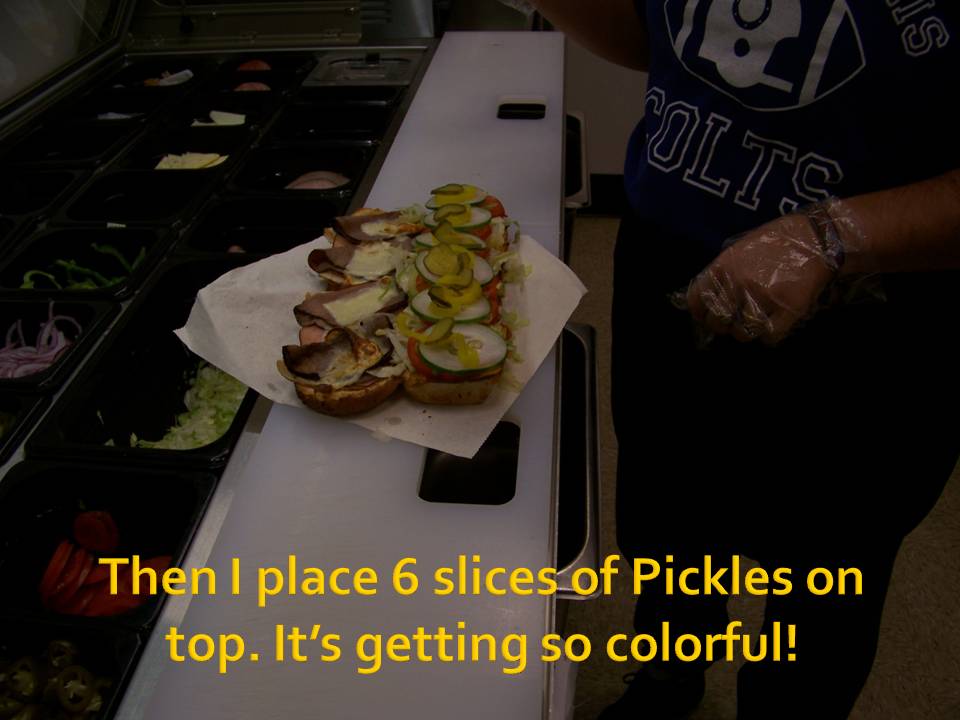 Sandwich being assembled with pickles on top. Text overlay reads: Then I place 6 slices of Pickles on top. It's getting so colorful!