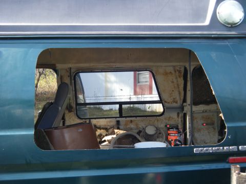 1981 Ford E350 - Interior view of a 1981 Ford E350 van, revealing exposed metal after panel removal.