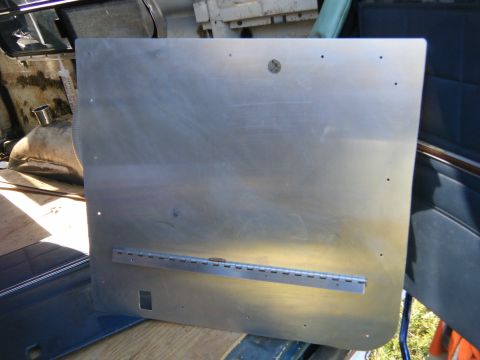 1981 Ford E350 - An aluminum interior door panel, possibly from a van, is shown with a visible hinge and a rectangular cutout.