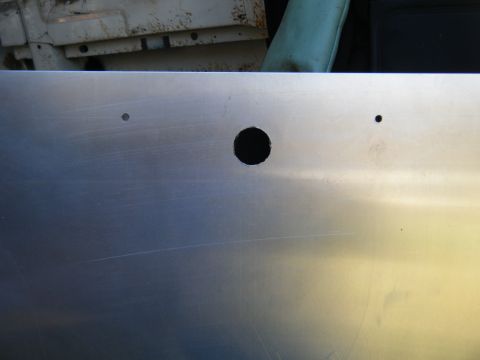 1981 Ford E350 - A metal panel with several drilled holes is shown, with some background elements visible.