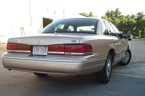 2001 Ford Crown Victoria - Rear view of a tan 2001 Ford Crown Victoria sedan parked outdoors.