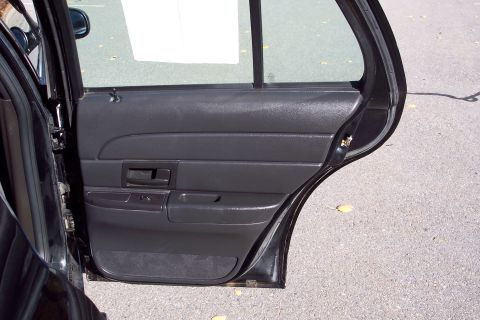 2001 Ford Crown Victoria - Interior view of a car's rear door panel and frame.