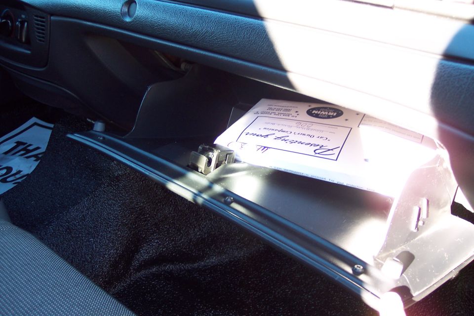 Open glove compartment showing a document with 'Irwin' logo and 'Passenger Compartment' text
