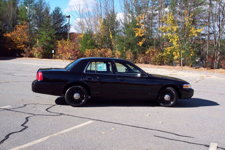 Black 2001 Ford Crown Victoria sedan, side view