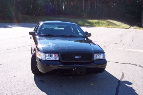 2001 Ford Crown Victoria - A black Ford Crown Victoria is parked outdoors, facing the camera with its front end prominent.