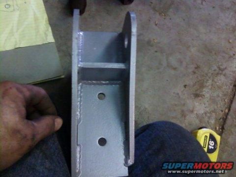 1995 Ford Bronco - A metal bracket is shown with a hand and a tape measure in the background.
