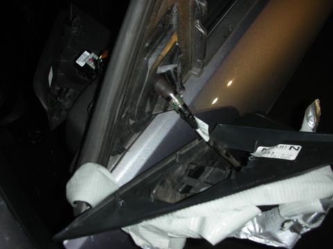 1998 Ford Crown Victoria - This damaged interior panel shows signs of repair with tape and exposed wiring.