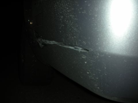 1998 Ford Crown Victoria - The car's bumper has significant damage, including scrapes and a dent.