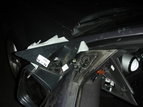 1998 Ford Crown Victoria - A close-up view of a damaged car interior component, showing internal wiring and labels.