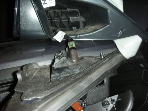 1998 Ford Crown Victoria - Exposed wiring and damaged plastic trim inside a vehicle's interior.