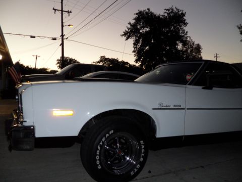 1973 Ford Ranchero - A white Ford Ranchero 500 is parked outside with another vehicle visible in the background at twilight.