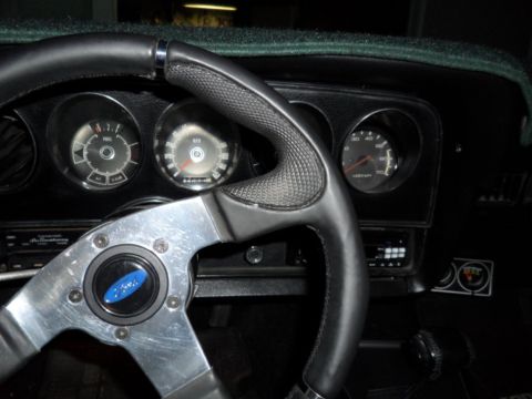 1973 Ford Ranchero - The interior of a 1973 Ford Ranchero shows a custom steering wheel and a dashboard with multiple gauges.