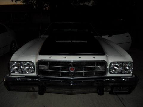 1973 Ford Ranchero - Front view of a white 1973 Ford Ranchero with a black hood and chrome accents.