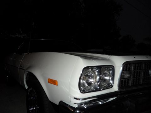 1973 Ford Ranchero - Front quarter view of a white 1973 Ford Ranchero, its chrome grille and dual headlights.
