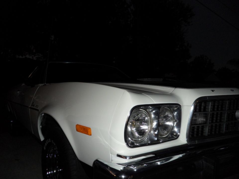 White 1973 Ford Ranchero front quarter view with chrome grille and dual headlights