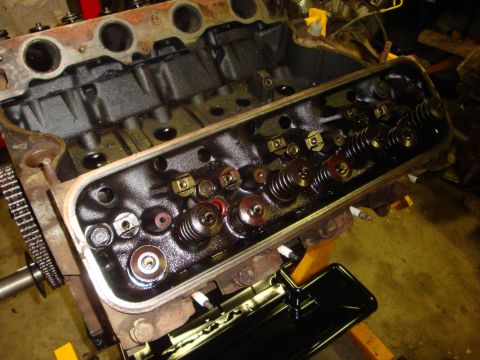 1989 Ford Bronco - Close-up of an engine's cylinder head, showing internal components like valves and springs.