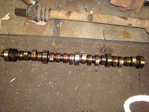 1989 Ford Bronco - Camshaft and driveshaft components shown on a workshop floor.