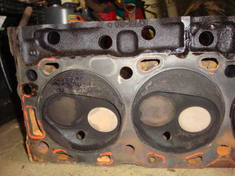 1989 Ford Bronco - This engine part shows signs of wear and tear, with rust and carbon buildup visible on the valves.