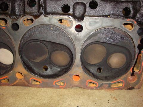 1989 Ford Bronco - Close-up of an engine cylinder head, revealing internal components and signs of wear and tear.
