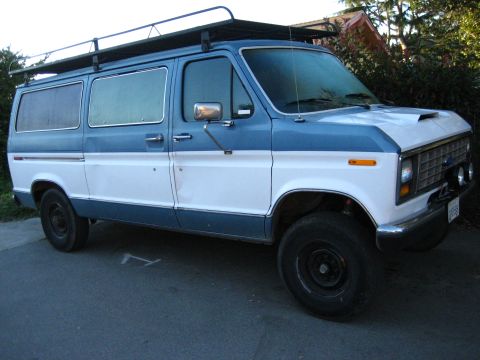 1989 Ford Bronco - This van has a two-tone paint job and a roof rack, suggesting it's set up for adventure.