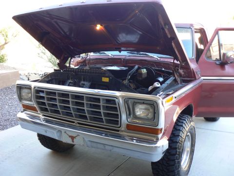 1978 Ford Bronco - Front view of a 1978 Ford F-150 pickup truck, hood open, revealing the engine compartment.