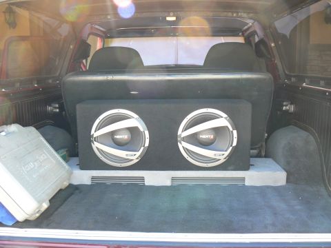 1978 Ford Bronco - Vehicle interior cargo area with a large subwoofer box and a storage container visible.