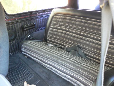 1978 Ford Bronco - Rear bench seat and interior panel of a 1978 Ford Bronco.