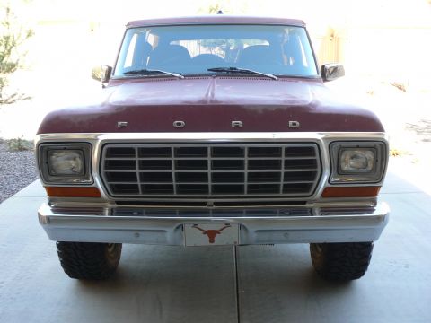 1978 Ford Bronco - Front view of a maroon 1978 Ford Bronco with a prominent chrome grille and a Texas Longhorns license plate frame.