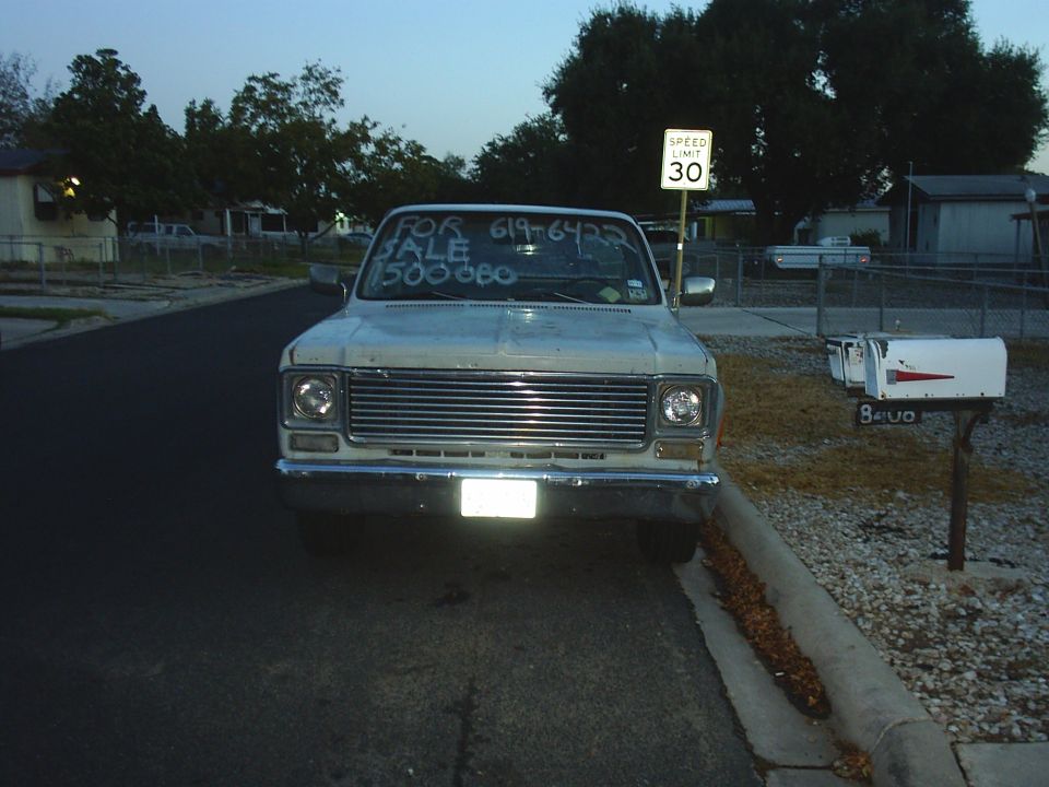 1978 Chevrolet C/K Pickup truck parked on street, front view. "FOR SALE 619-6422 1500000" written on windshield