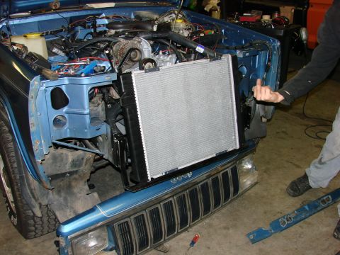 1991 Jeep Comanche - Radiator removed from 1991 Jeep Comanche engine bay for service.