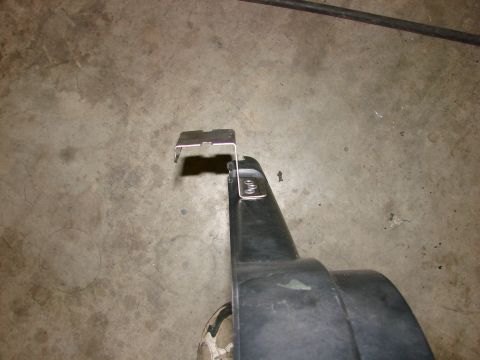 1991 Jeep Comanche - Close-up of a black plastic part with a metal bracket, likely a vehicle component.