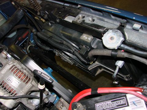 1991 Jeep Comanche - Close-up view of engine bay components including the alternator and radiator cap.