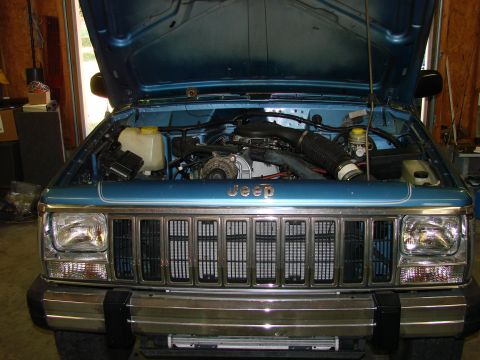 1991 Jeep Comanche - Front view of a 1991 Jeep Comanche engine bay, highlighting the grille and engine components.