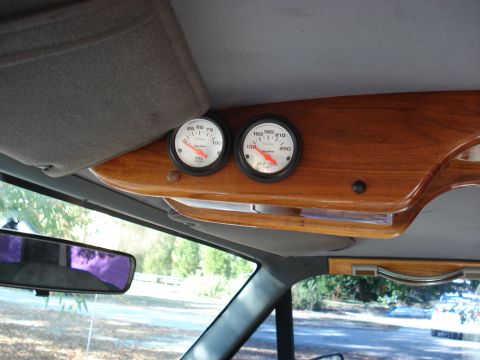 1992 Ford C-350 (Centurion Conversions) - Wood-grain overhead console mounting two white-face aftermarket gauges for oil pressure and water temperature.