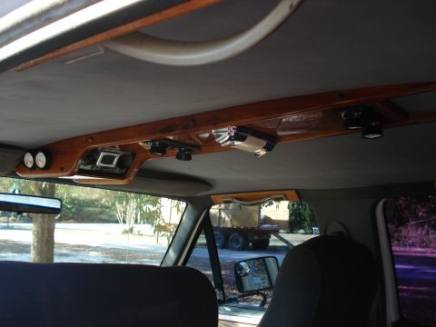 1992 Ford C-350 (Centurion Conversions) - Interior overhead view of a vehicle showing a custom wood-grain overhead console with recessed spotlights, two auxiliary gauges, and switch…