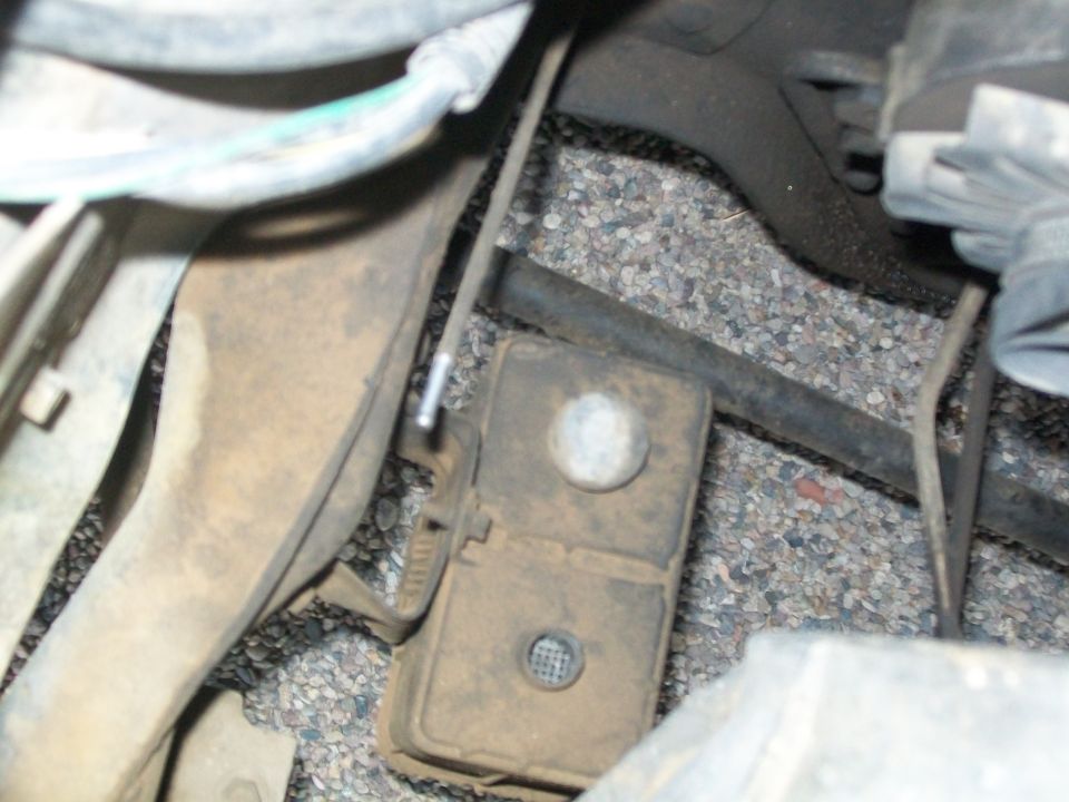 Undercarriage component with wires and a Supermotors.net watermark