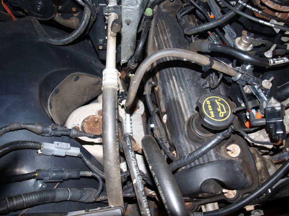 Engine bay detail with black valve cover and yellow 5W-20 oil filler cap