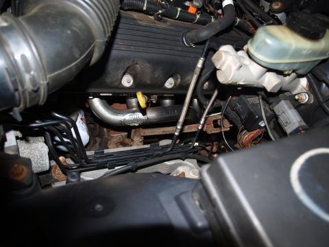 1998 Ford Crown Victoria - Close-up view of an engine compartment custom exhaust headers and various engine components.
