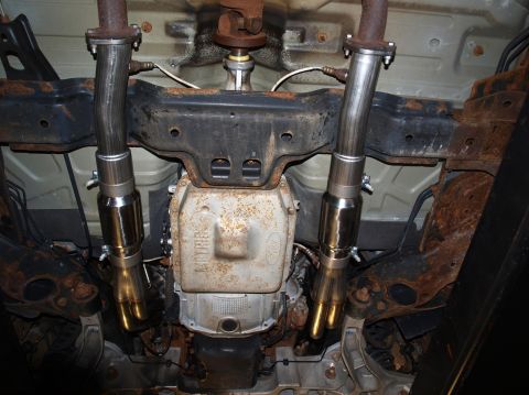 1998 Ford Crown Victoria - Looking straight up from under the car at a pair of stainless header collectors and heat-tinted mid-pipes with band clamps and oxygen senso…